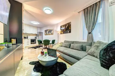 a living room with a couch and a table at Boutique Apartment DOLCHE VITA in Smolyan
