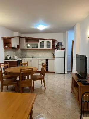 a kitchen and dining room with a table and chairs at Скиелит 5 in Pamporovo
