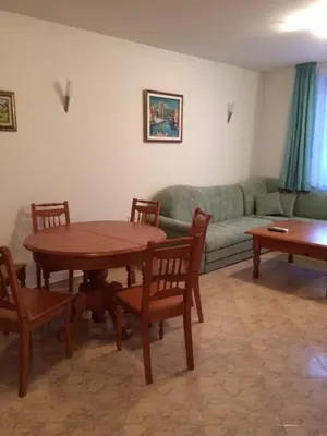 a living room with a table and a couch at Скиелит 3 in Pamporovo