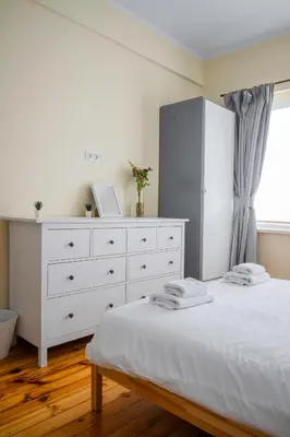 a white bedroom with a white dresser and a bed at Stylish CityHub Retreat in Sofia Center by Flat Mаnager in Sofia