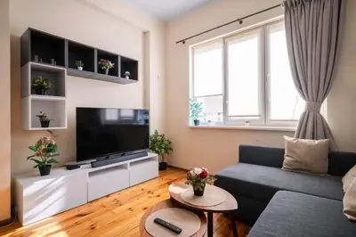 a living room with a couch and a tv at Stylish CityHub Retreat in Sofia Center by Flat Mаnager in Sofia