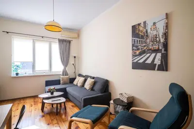 a living room with a couch and a table at Stylish CityHub Retreat in Sofia Center by Flat Mаnager in Sofia