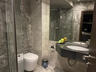 a bathroom with a sink and a toilet and a shower at Мия 2 Deluxe Royal Spa in Velingrad
