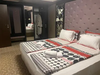 a bedroom with a large bed with a large mirror at Мия 2 Deluxe Royal Spa in Velingrad