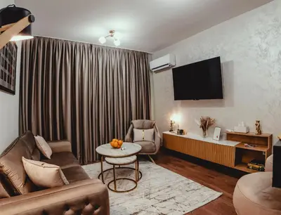 a living room with a couch and a tv at Elegant Living Apartment 2 in Sofia