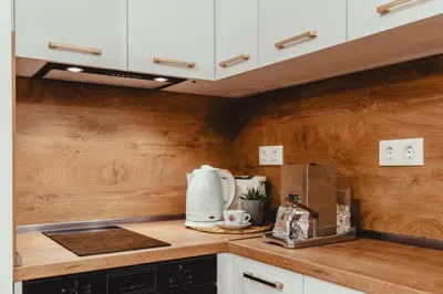 a kitchen with white appliances and wooden walls at Elegant Living Apartment 2 in Sofia