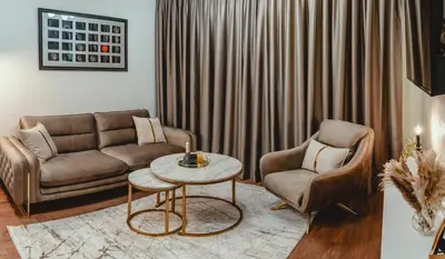 a living room with a couch and a table and two chairs at Elegant Living Apartment 2 in Sofia
