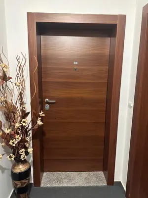 a wooden door in a hallway with a plant at Elegant Living Apartment 1 in Sofia