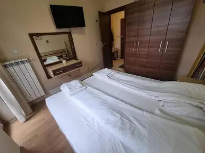 a large white bed in a room with a mirror at Domo 12 Belmont, Bansko in Bansko