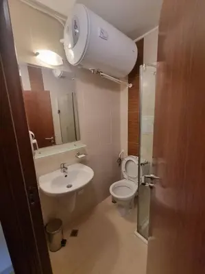 a bathroom with a toilet and a sink and a mirror at Domo 12 Belmont, Bansko in Bansko