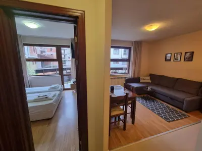 a living room with a couch and a table at Domo 12 Belmont, Bansko in Bansko