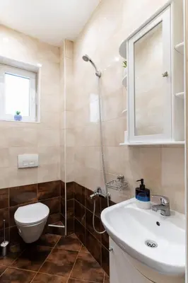 a bathroom with a toilet and a sink and a shower at Victor Hugo Studio in Sofia