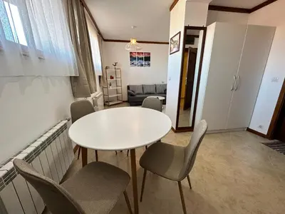 a room with a table and chairs and a couch at St Ivan Rilski SPA Studio in Bansko