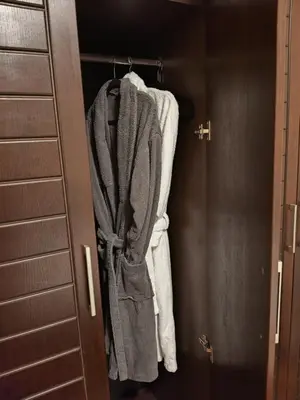 a closet with towels hanging on a door at Pravets spa resort apartments in Pravets