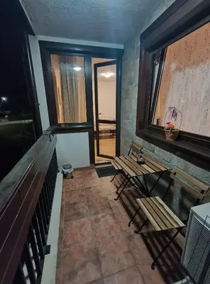 a room with two benches and a window at Pravets spa resort apartments in Pravets