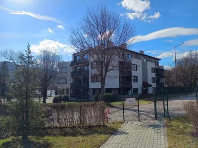 an apartment building with a fence in front of it at Pravets spa resort apartments in Pravets