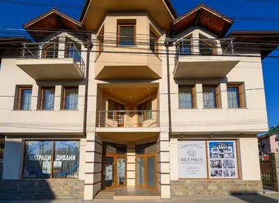 a large white building with a brown roof at Rila Hills in Samokov