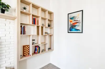 a book shelf on a wall with books at Skyline View - Very Central - Metro - Washer&Dryer in Sofia