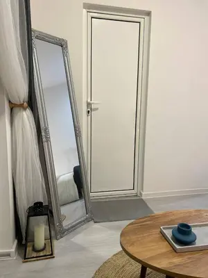 a room with a mirror and a table and a table sidx sidx sidx at Pirotska Modern Room in Sofia