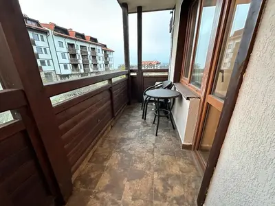a balcony with a table and some windows at Luxury apartments in Downtown Residential Complex in Bansko