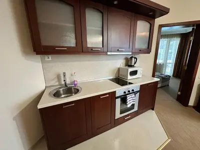 a kitchen with a sink and a microwave at Luxury apartments in Downtown Residential Complex in Bansko