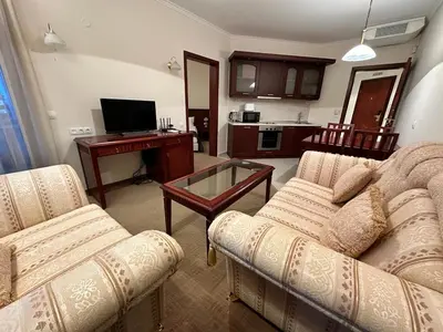 a living room with two couches and a table at Luxury apartments in Downtown Residential Complex in Bansko