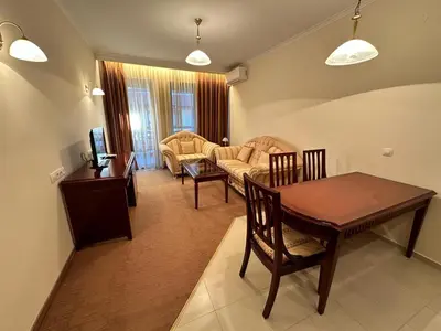 a living room with a table and a couch at Luxury apartments in Downtown Residential Complex in Bansko