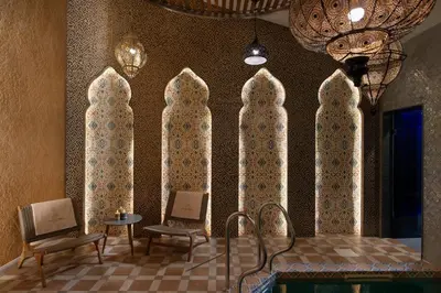 a room with three chairs and a table and windows at Alpine Bell Villa in Banya