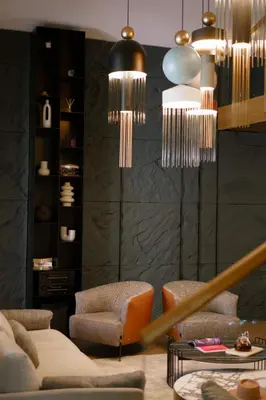 a living room with two chairs and chandeliers at Alpine Bell Villa in Banya