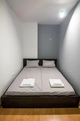a bedroom with a bed with two towels on it at Аpartment near Sofia airport in Sofia