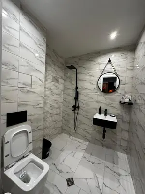 a bathroom with a toilet and a sink and a mirror at 1BR Modern condo near the University in Sofia