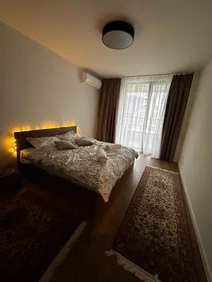 a bedroom with a bed and a large window at 1BR Modern condo near the University in Sofia