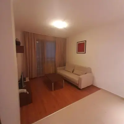 a living room with a couch and a table at Апартамент Belvedere G106 in Bansko