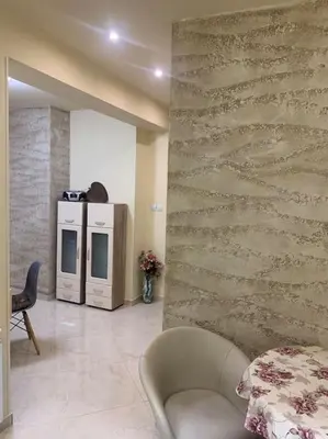 a living room with a stone wall and a chair at Lena in Sofia
