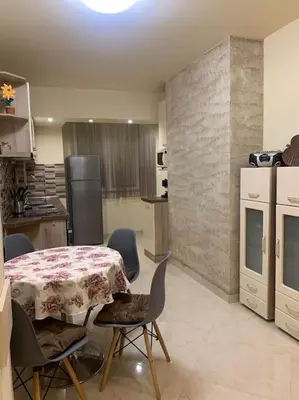 a kitchen with a table and chairs in a kitchen at Lena in Sofia