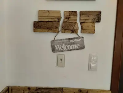 a welcome sign is hanging on a wall at Апартаменты в Belvedere in Bansko