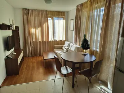 a living room with a table and a couch at Апартаменты в Belvedere in Bansko