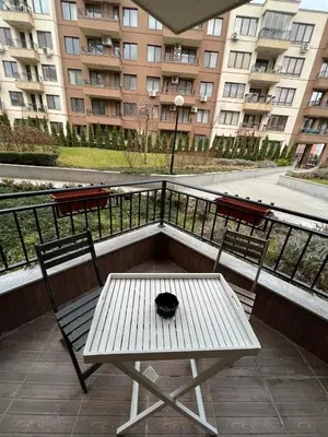 a black cat sitting on a table on a balcony at Boston Cozy Elegant Family Apt w Parking Near NSA in Sofia