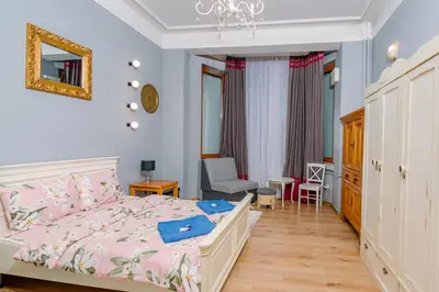 a bedroom with a bed with a pink comforter at Top Center, 3BDR, Heart of the city, FREE Secured Parking in Sofia