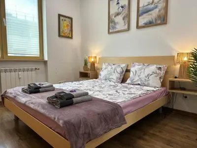 a bedroom with a bed with two towels on it at Rakovski Residence in Sofia