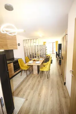 a kitchen and dining room with a table and yellow chairs at SOFIA CENTRAL LUXURY apartment 