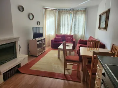 a living room with a couch and a dining room at One bedroom Apartment in Bansko