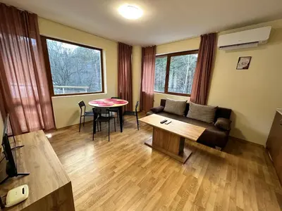 a living room with a couch and a table at Pine Tree one bedroom apartment in Bansko