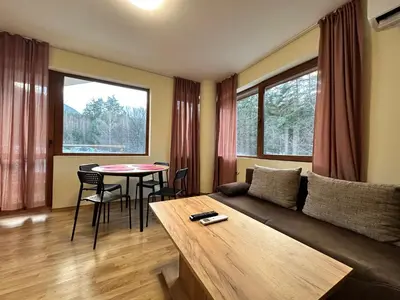 a living room with a couch and a table at Pine Tree one bedroom apartment in Bansko
