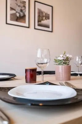 a table with a plate and a wine glass on it at Orange friendly apartment near Vitosha blvd in Sofia