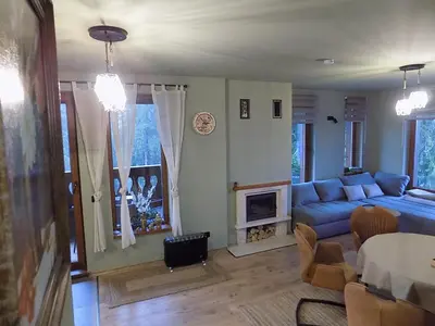 a living room with a blue couch and a fireplace at La'Vista in Smolyan