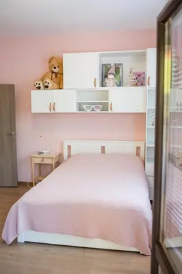 a bedroom with a white bed and shelves at Вила Маунтайн Вю in Brestnik