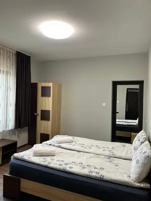 a bedroom with a large bed with pillows on it at Къща за гости Вила Смокиня град Хисаря in Hisarya