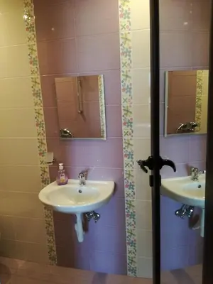 a bathroom with two sinks and two mirrors at Къща за гости Вила Смокиня град Хисаря in Hisarya
