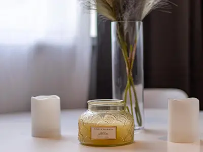 a jar of honey sitting on a table with a vase at Eiffel Elegance - Stylish Sofia Apartment in Sofia